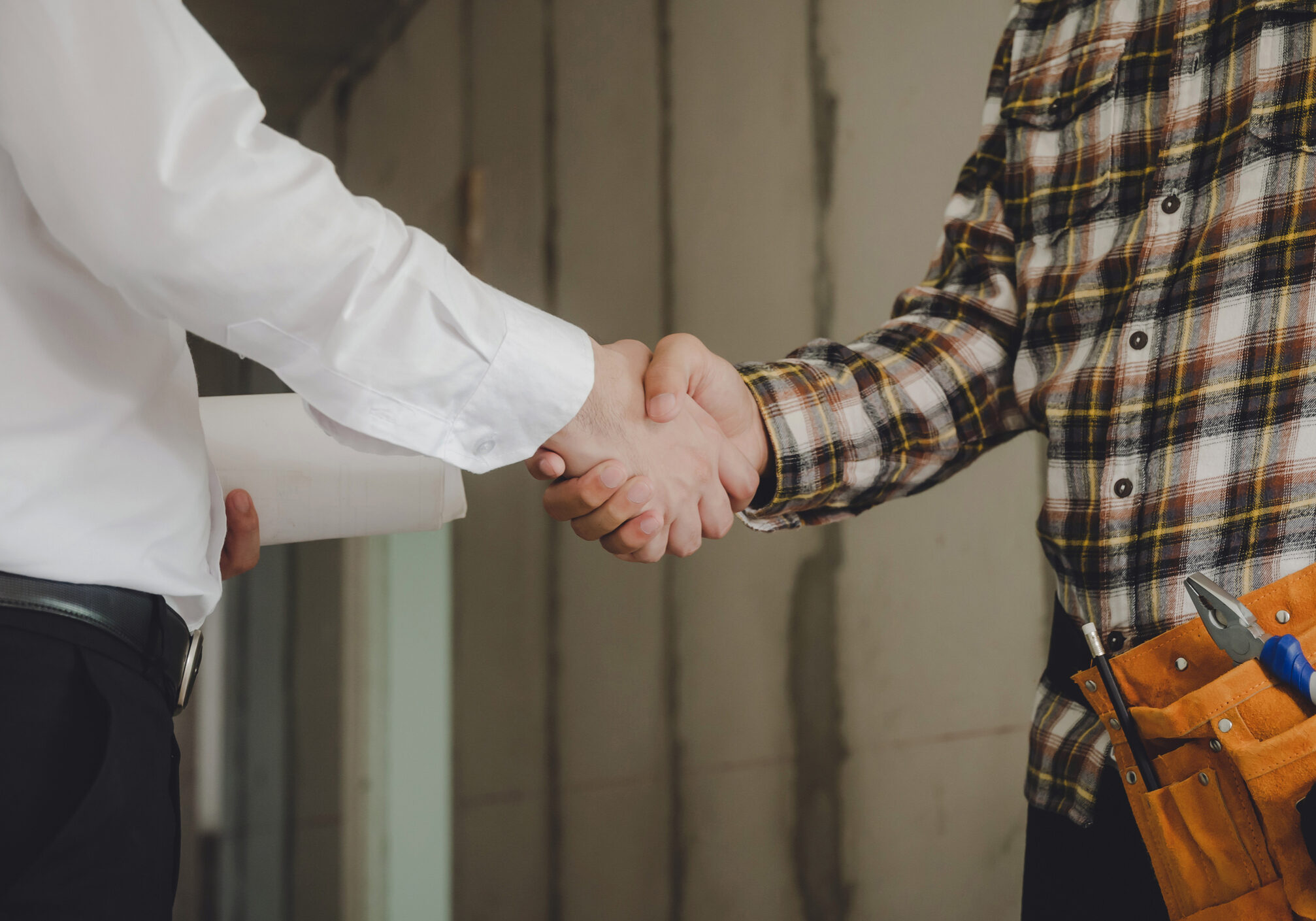 construction worker team contractor shaking hands with engineer after finishing up business meeting to start up project contract in construction site building, teamwork, partnership, industry concept